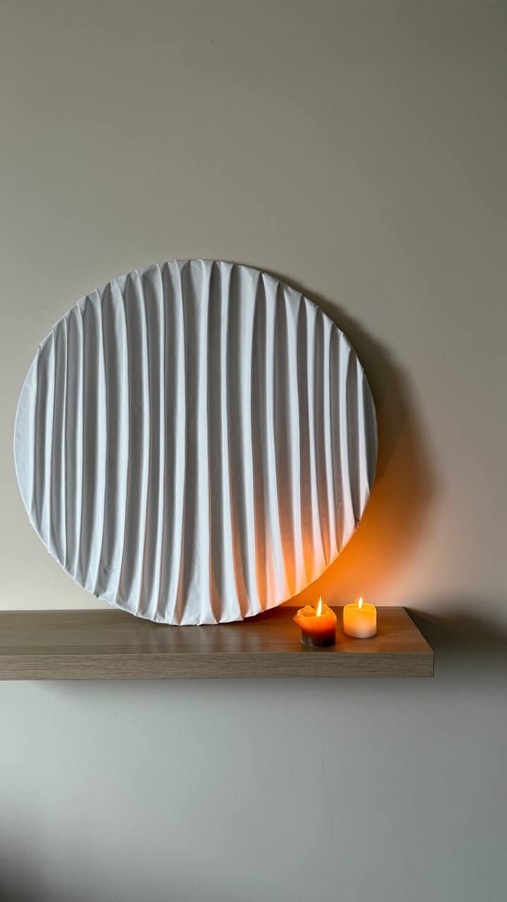 cuerdas, Ø80 cm — A round sculpture in coated fabric on a wooden base.