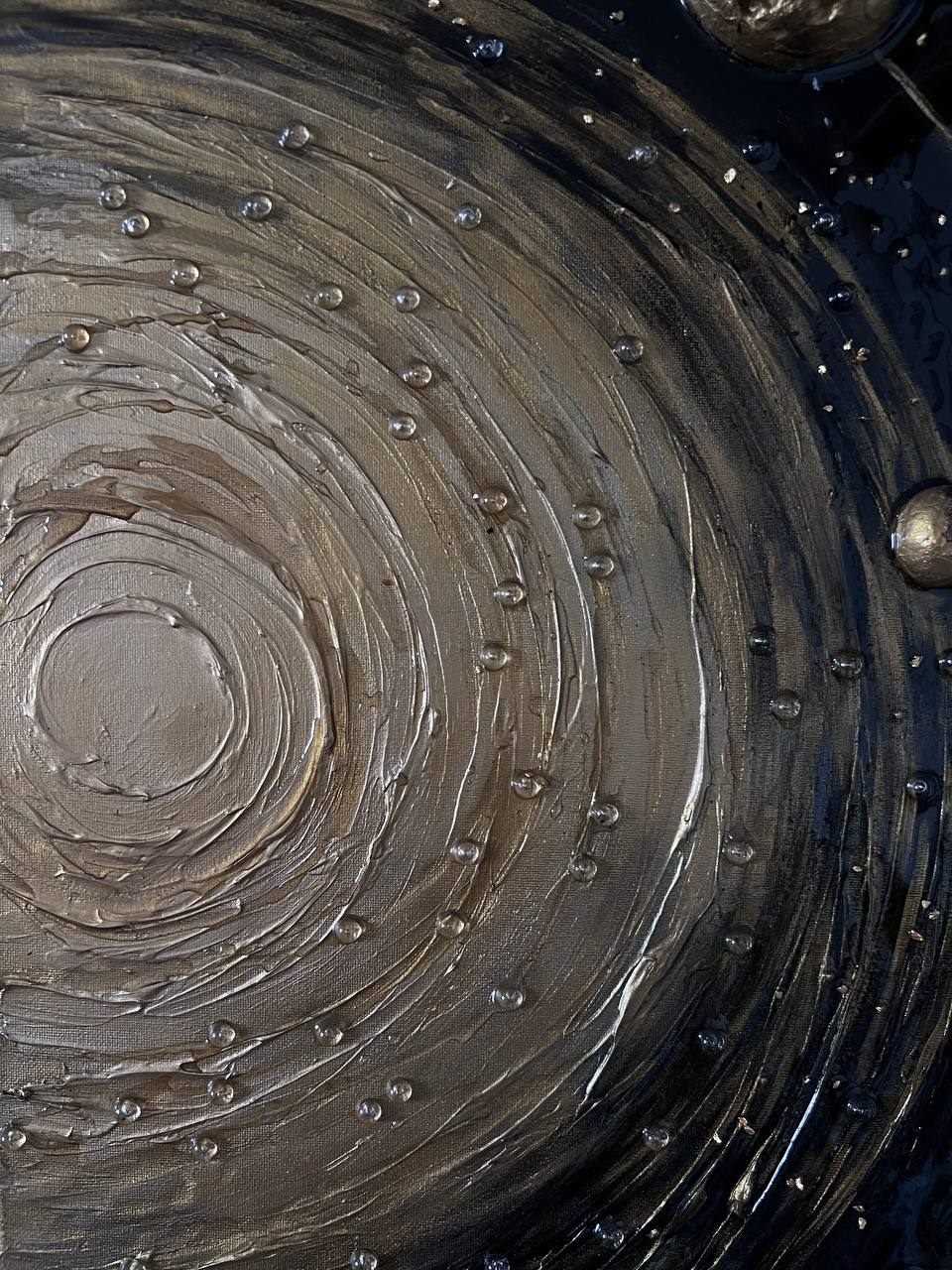 INFINITY, 40×100 cm — A glowing sun at the centre, concentric textured rings around it, gold planets standing out from the dark surface.